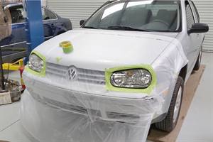 A Mk4 headlight lens mid-restoration.