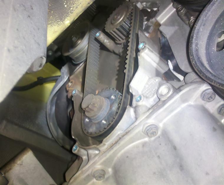 Pulleys and lower covers removed. Broken belt, teeth stripped off.